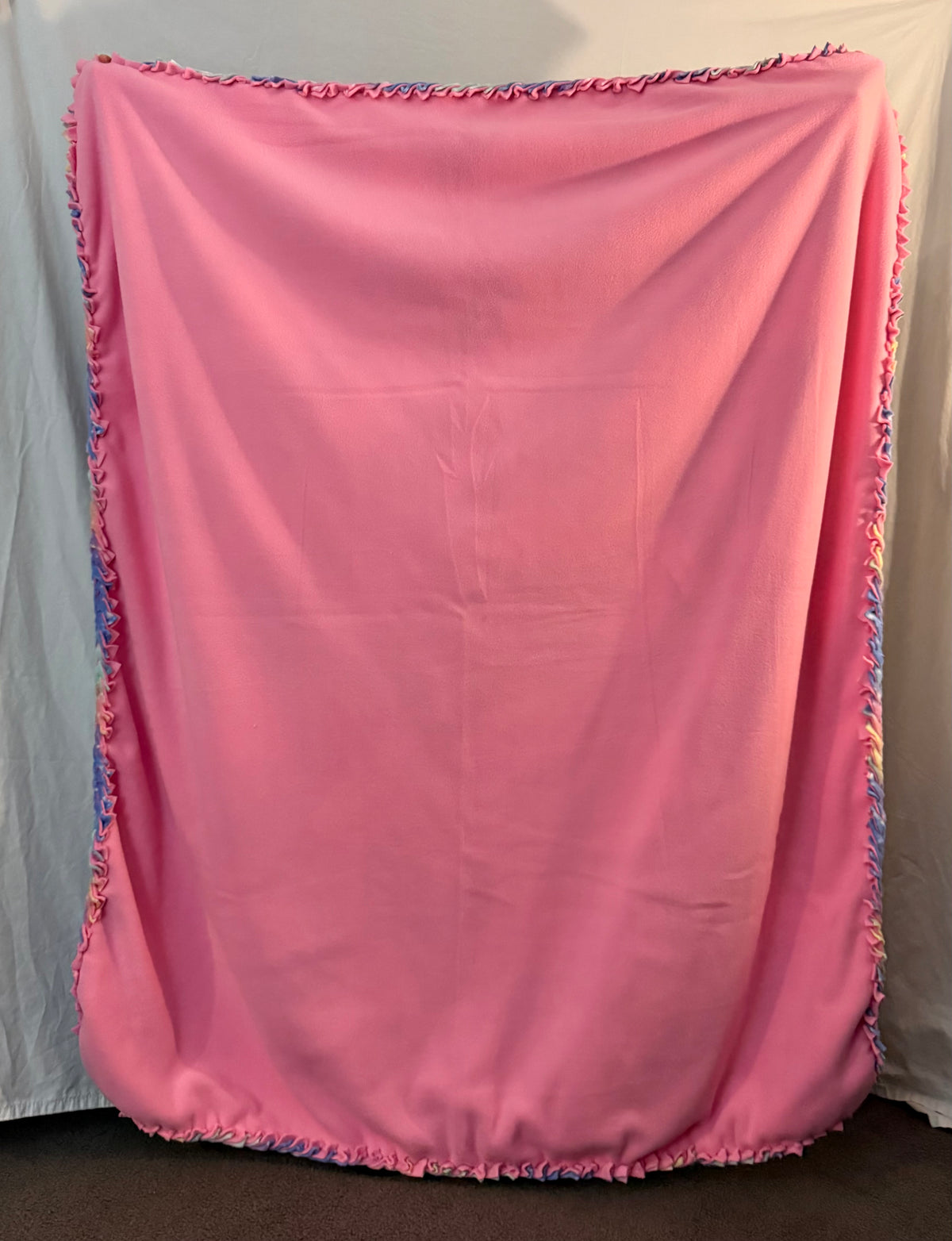 Solid pink side of fleece blanket