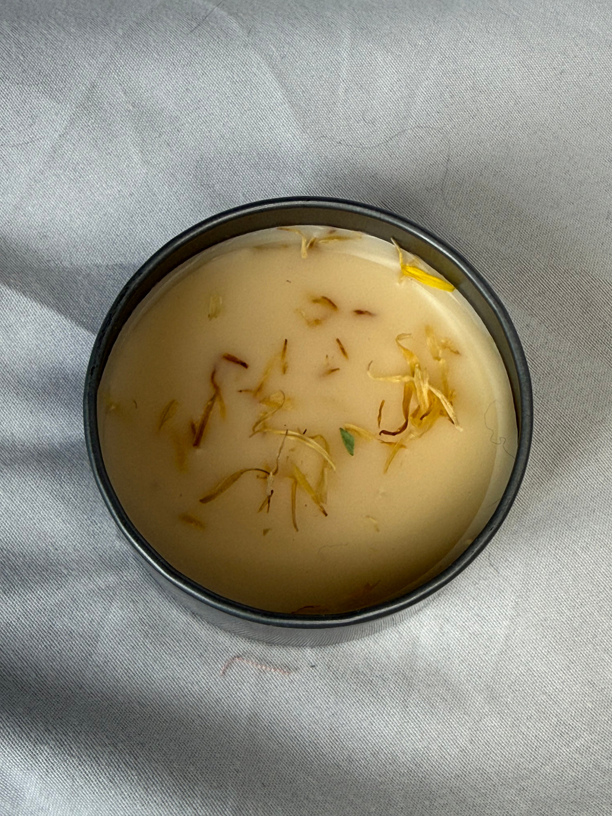Top view of Healing Paw Wax with calendula flowers